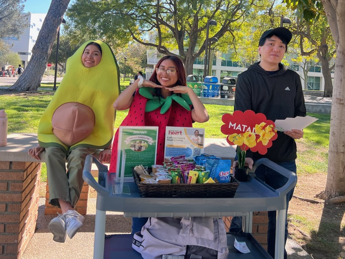 three team members at an outdoor cart