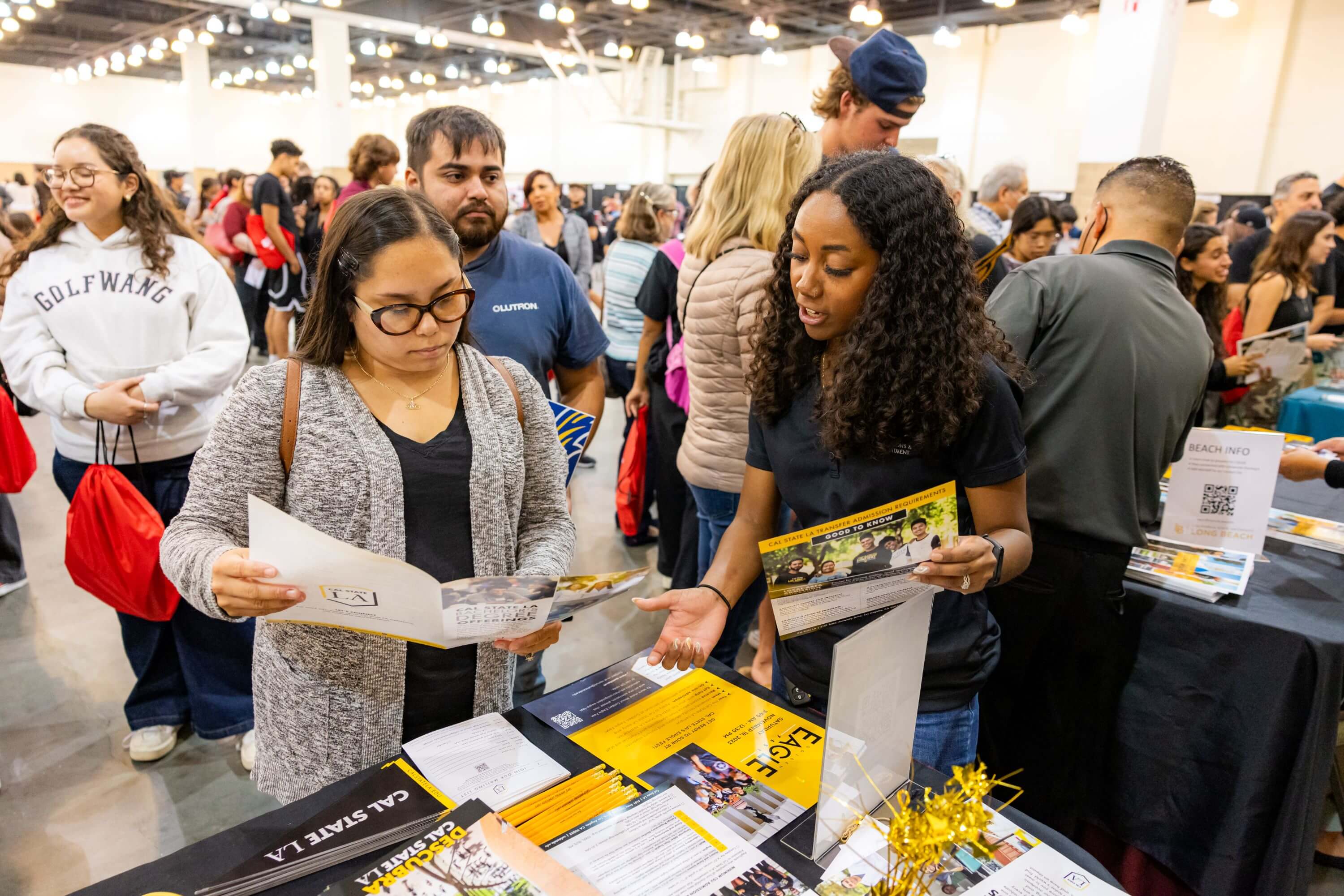 a college admissions staff member reading a pamphlet with a prospective student