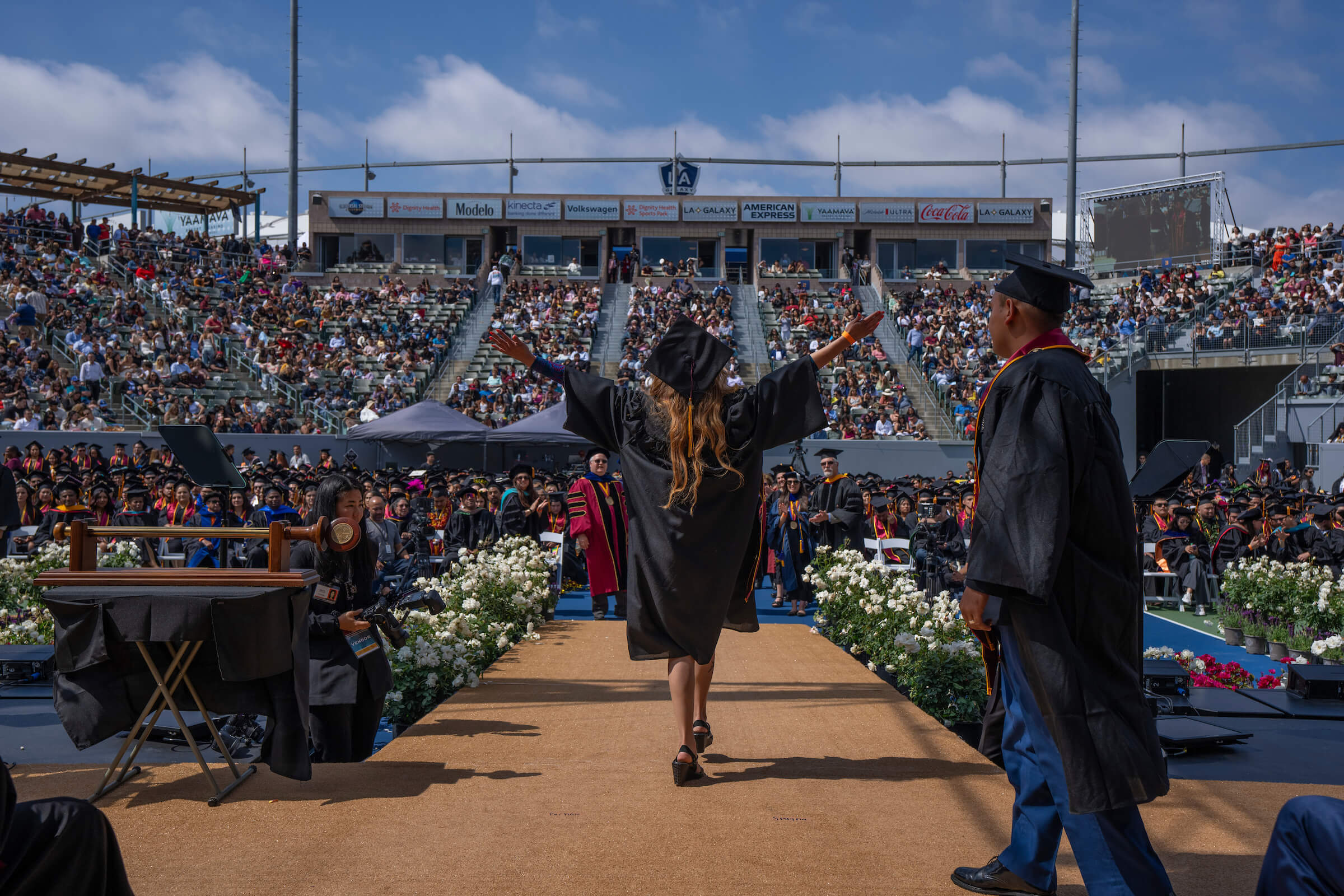 Graduate walking off stage at commencement