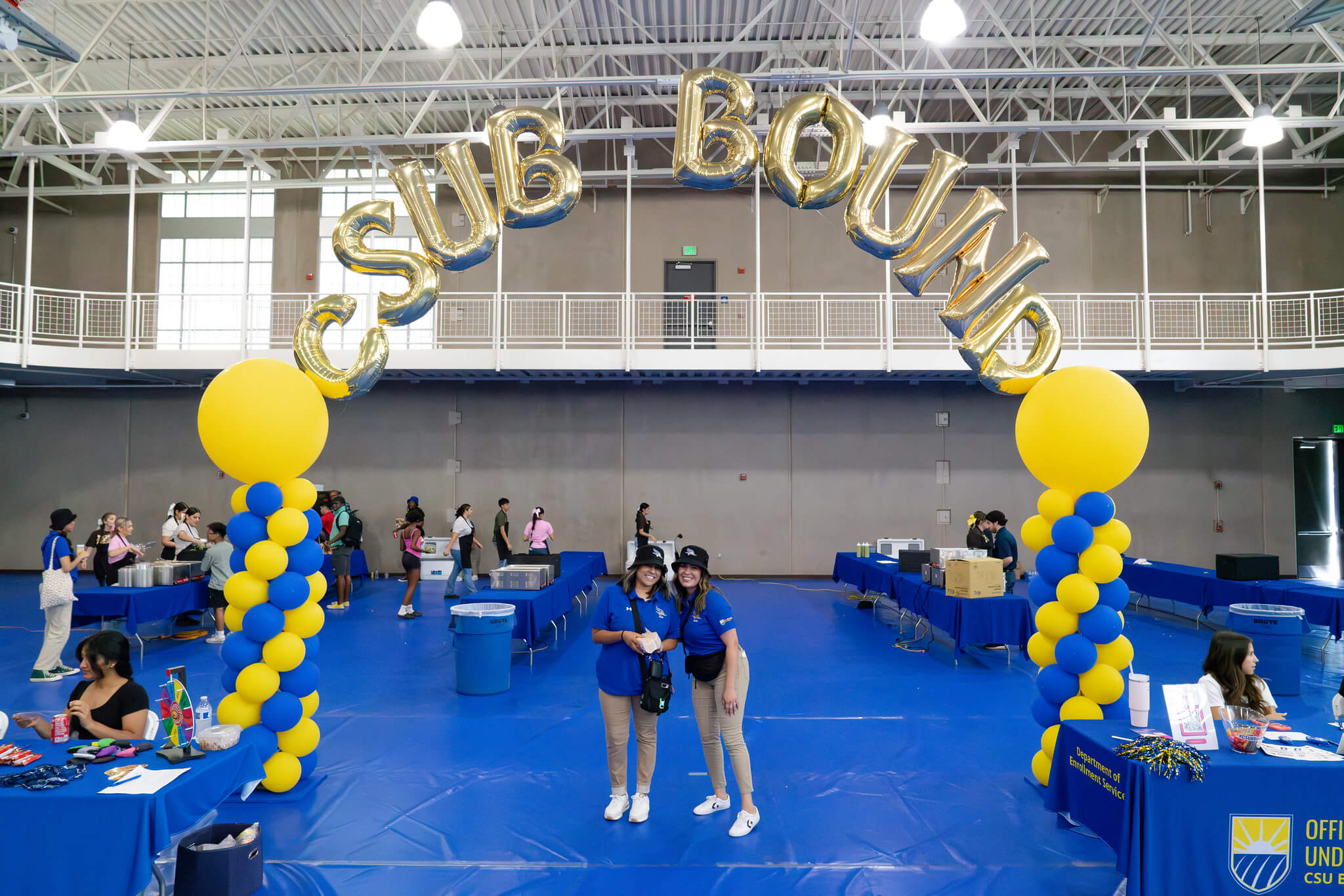 students under sign reading CSUB Bound