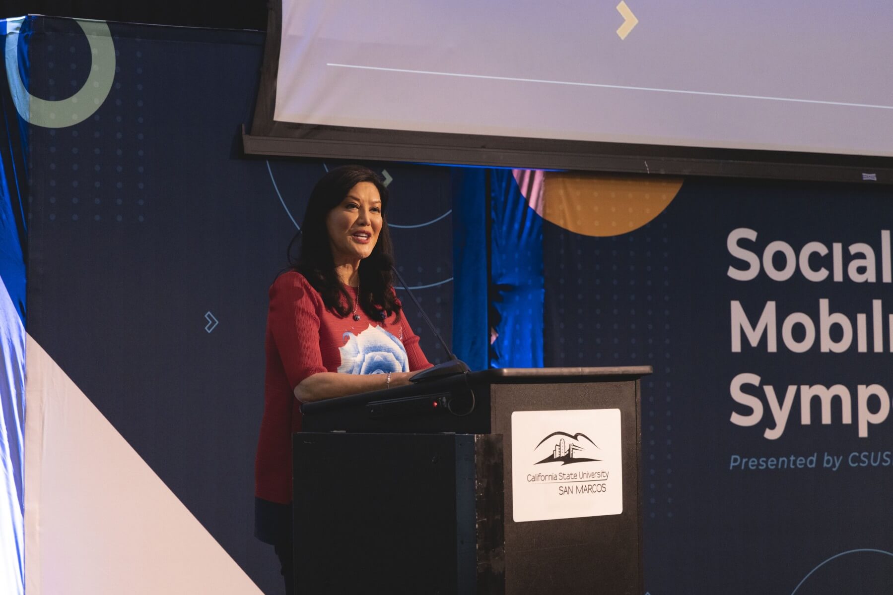 a woman speaking from behind a podium