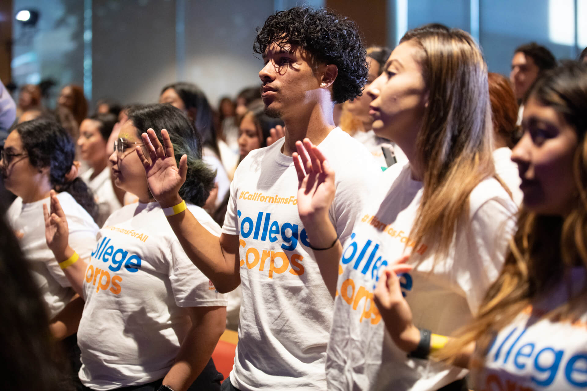 students wearing college corps t shirts taking an oath