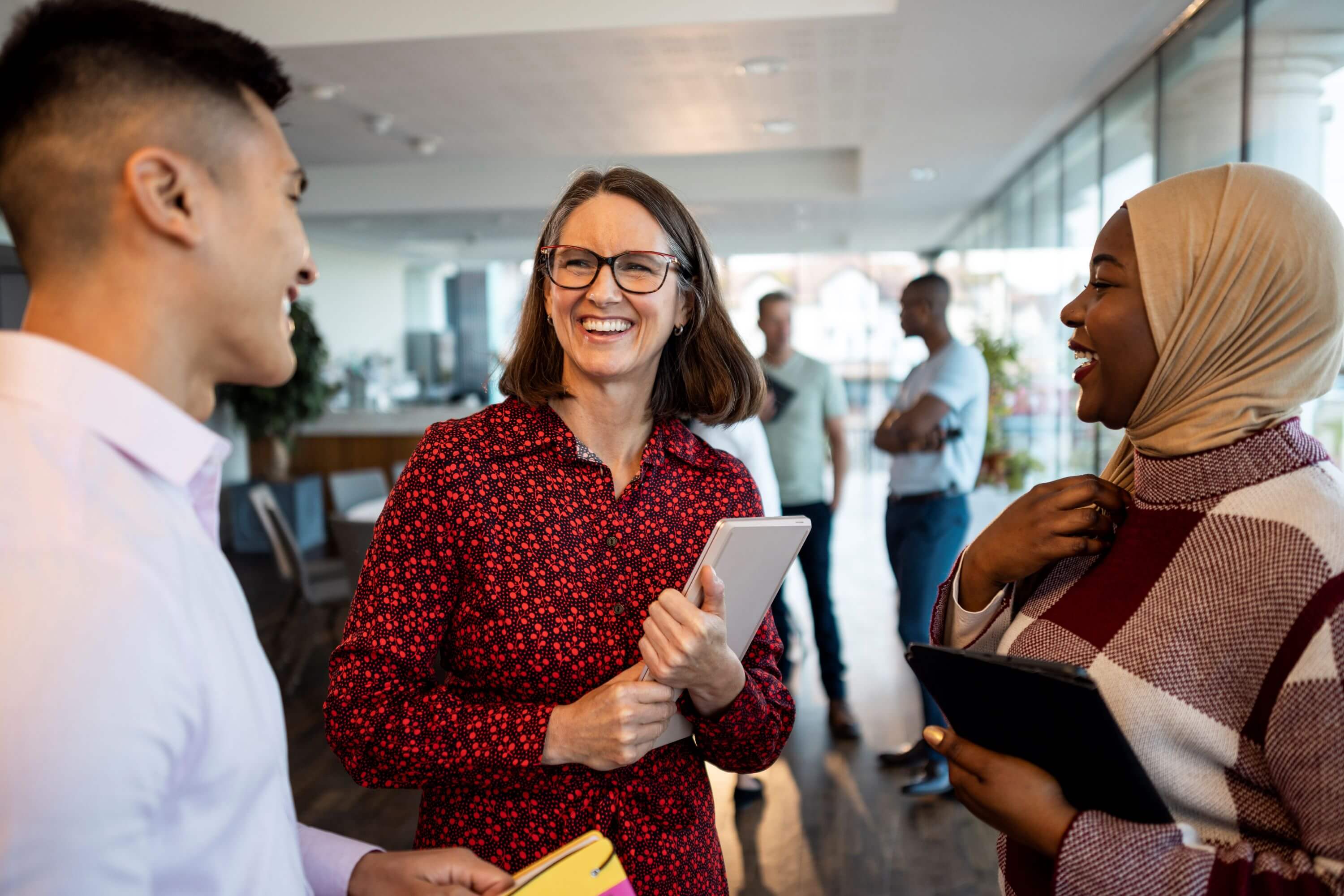 three coworkers laughing in an office