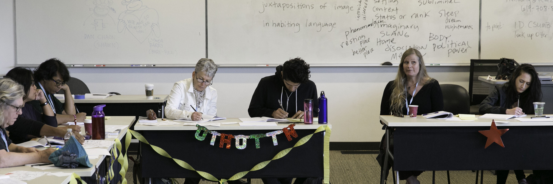 students writing in a classroom setting