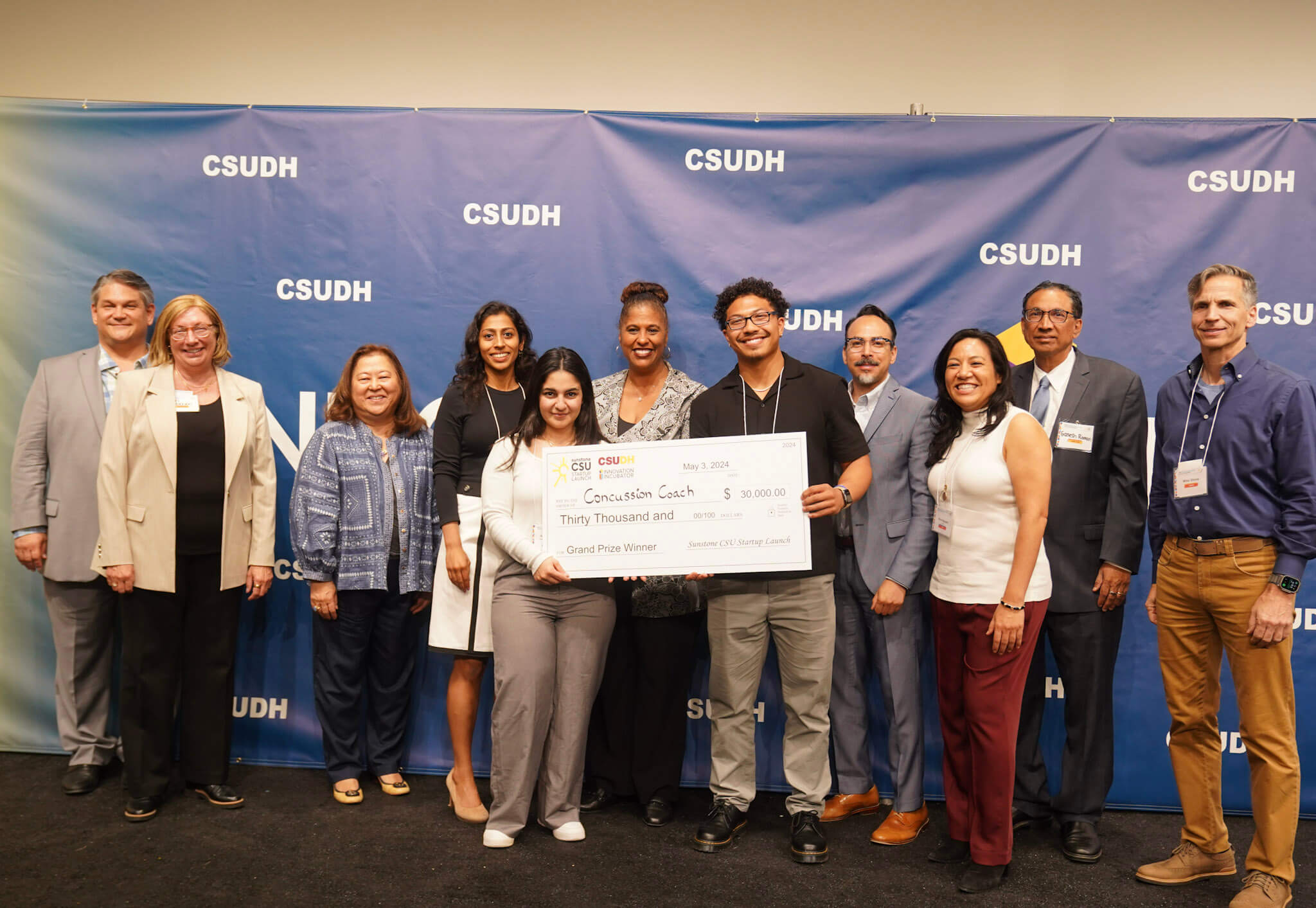 SJSU students Andrew Jenkins and Anna Vartan with their $30,000 prize check at the CSU Startup Launch competition