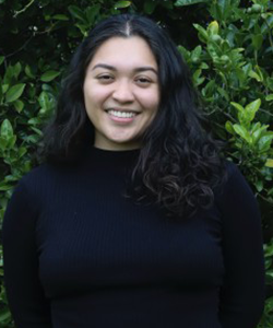 Natalia Castillo smiling in a black sweater.