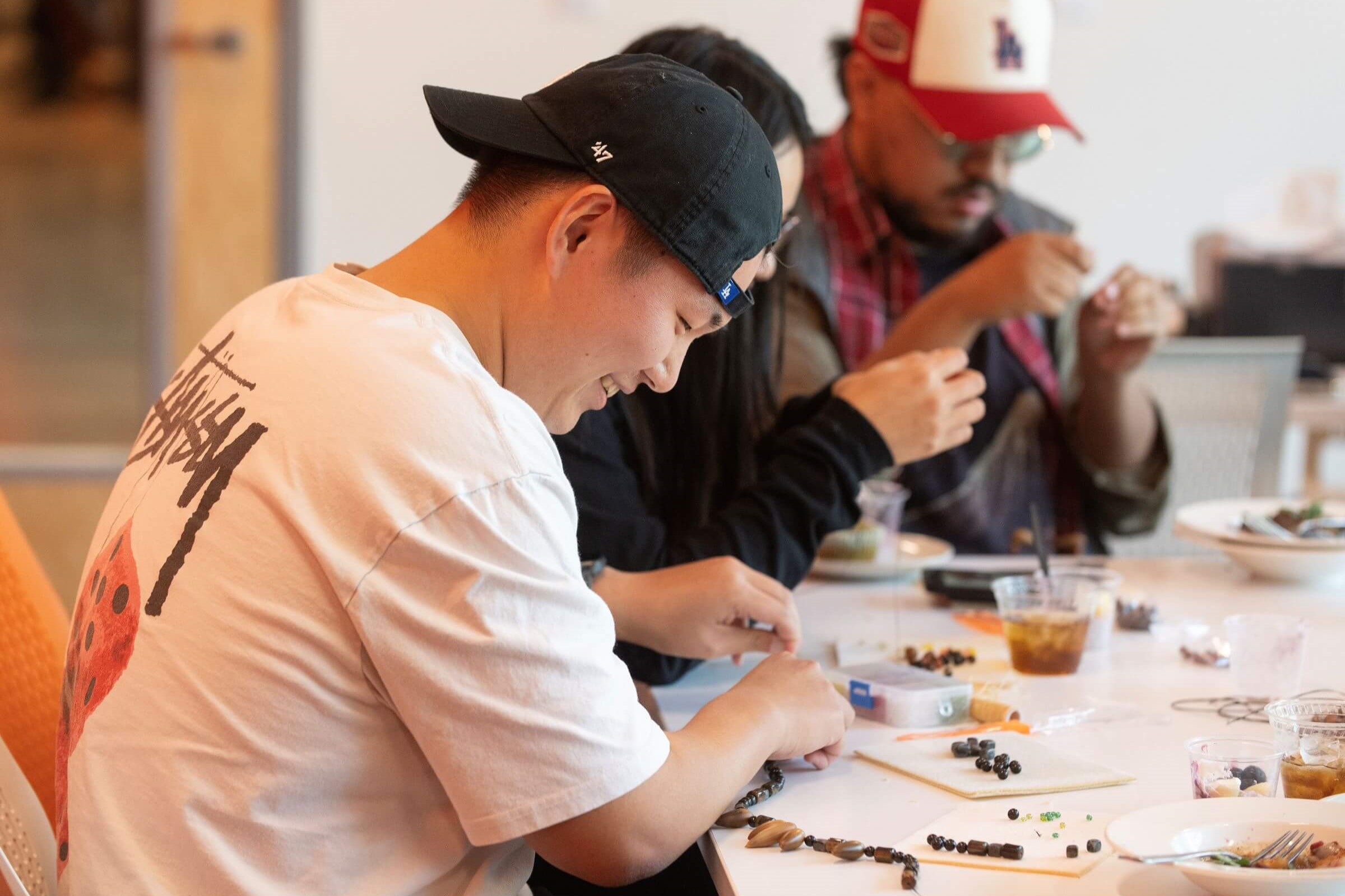 CPP student beading with acorns