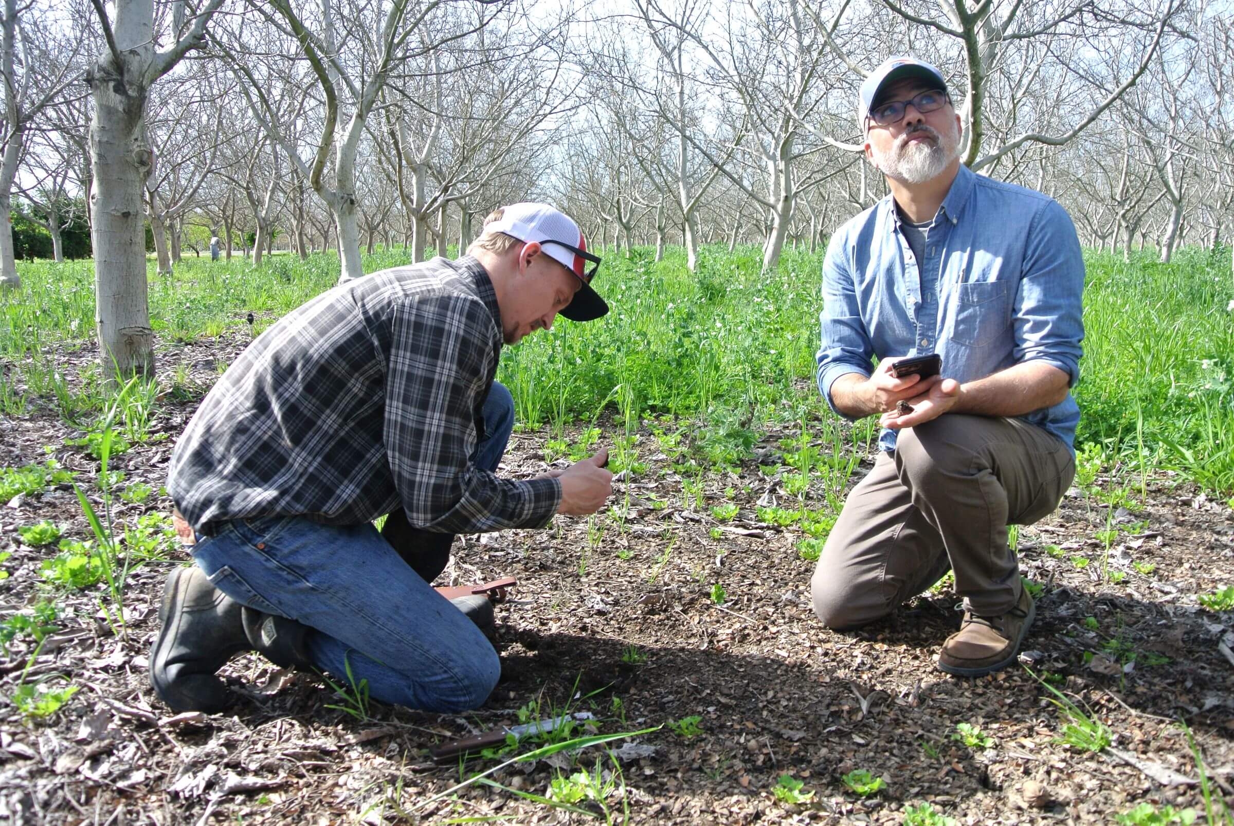 Ted Gailey and Benjamin Lewis examine soil