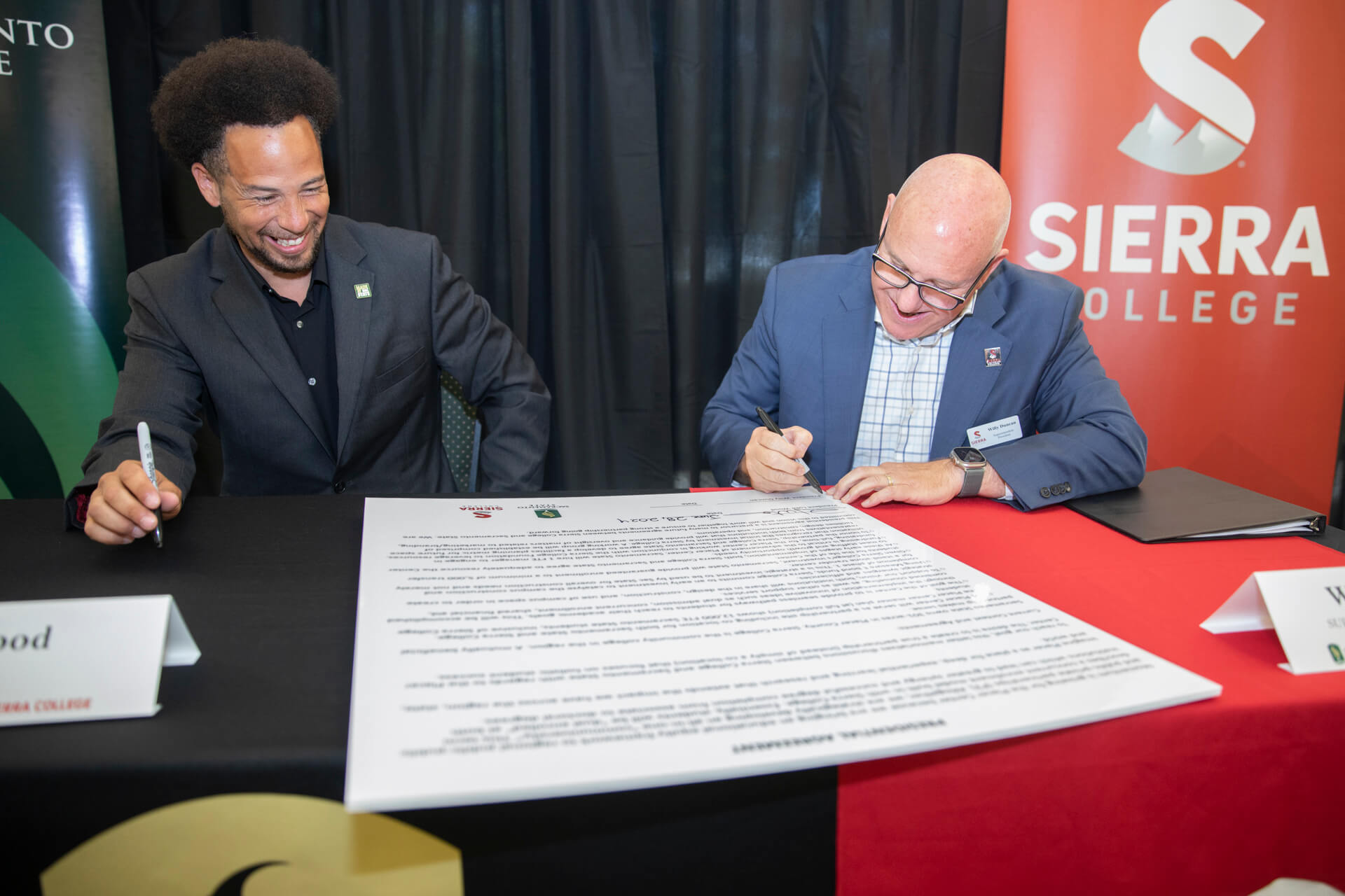 from left sacramento state president Luke Wood sign agreement with Sierra College president