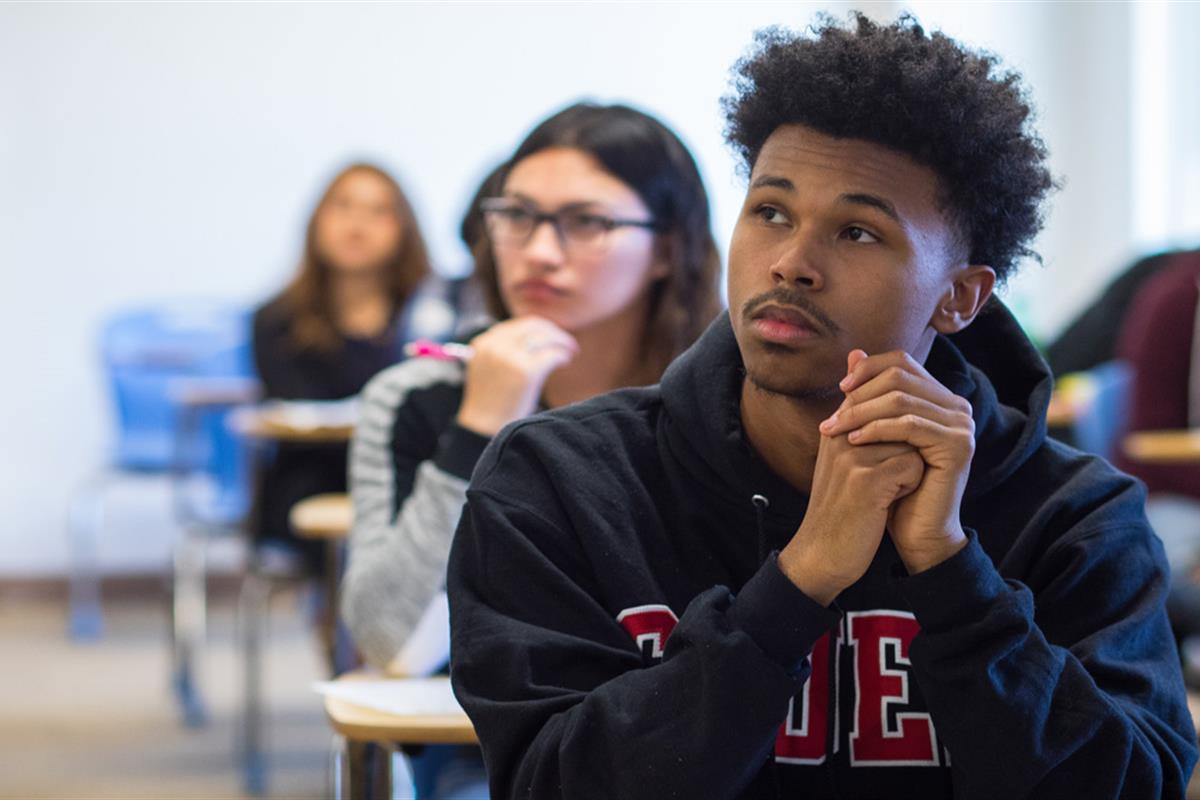 college students sitting at desks in a classroom