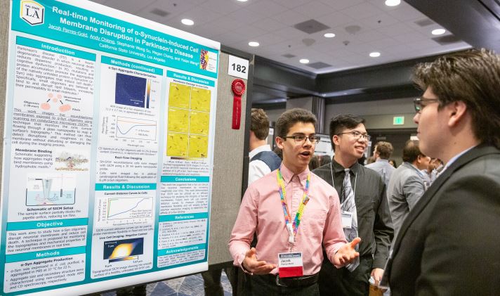 Mr. Jacob Parres-Gold (CSU Los Angeles) at his poster during the 32nd Annual CSU Biotechnology Symposium January 2020. Jacob Parres-Gold (CSU Los Angeles) investigates the molecular processes in the development of Parkinson’s disease (PD) in the Yixian Wang group. 